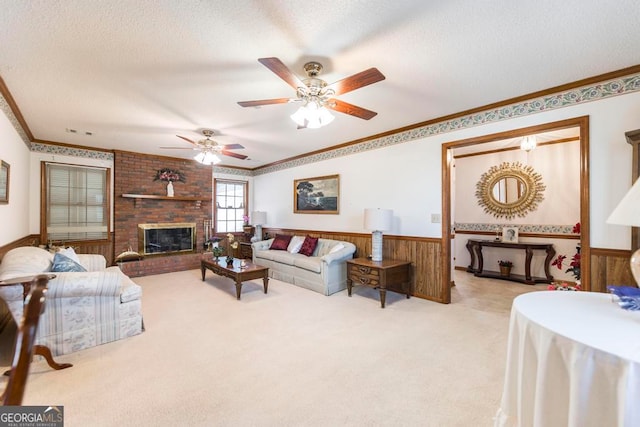 living room featuring light carpet, ceiling fan, a textured ceiling, crown molding, and wooden walls