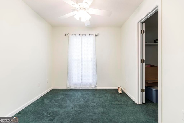 unfurnished bedroom featuring ceiling fan and dark carpet