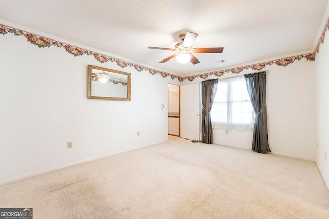 spare room featuring light colored carpet and ceiling fan