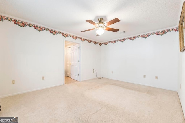 spare room featuring light colored carpet and ceiling fan