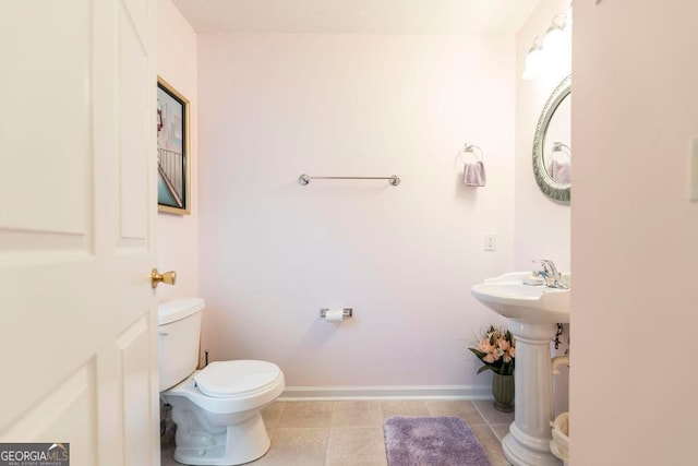 bathroom featuring tile patterned floors, toilet, and sink