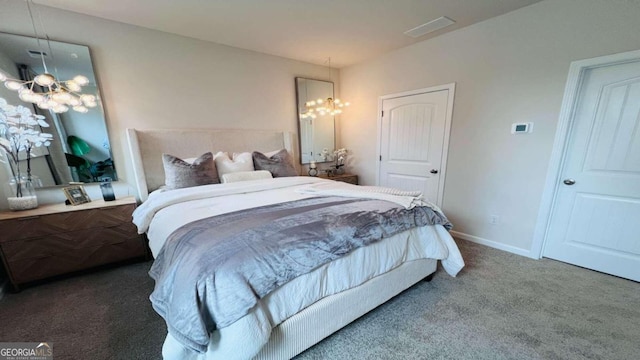 bedroom featuring a chandelier and carpet flooring