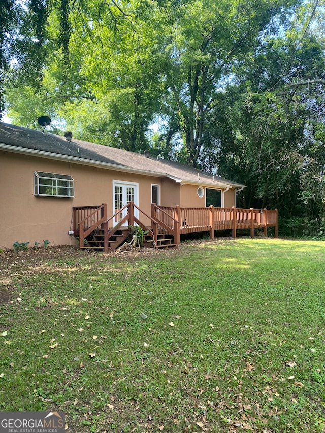 back of house with a yard and a deck