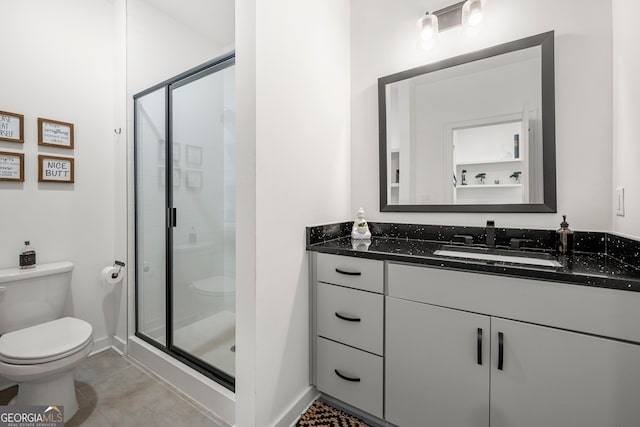 bathroom featuring tile patterned flooring, vanity, an enclosed shower, and toilet