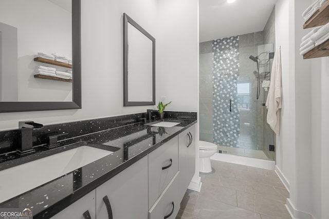 bathroom featuring vanity, toilet, and a shower with door