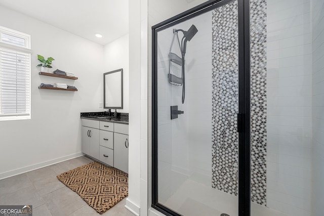 bathroom with walk in shower, vanity, a wealth of natural light, and tile patterned flooring