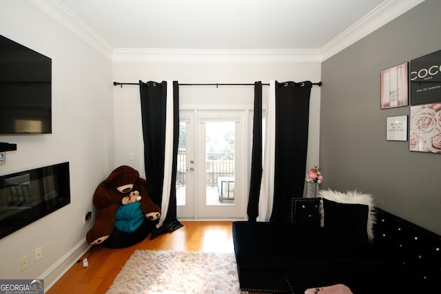 entryway with hardwood / wood-style flooring and crown molding