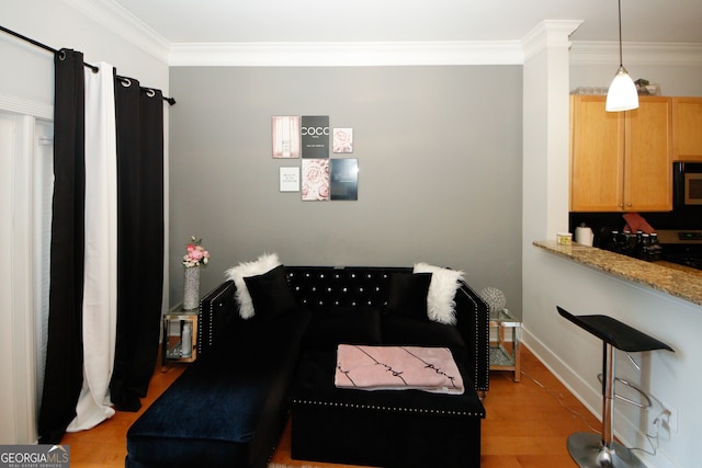 living room with light hardwood / wood-style flooring and crown molding