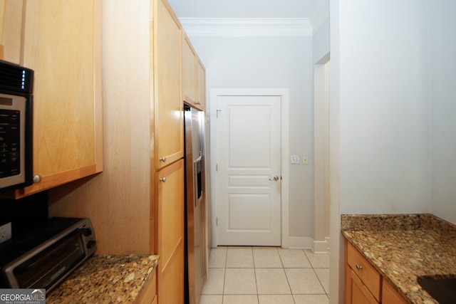 kitchen with stone countertops, crown molding, light tile patterned floors, and appliances with stainless steel finishes