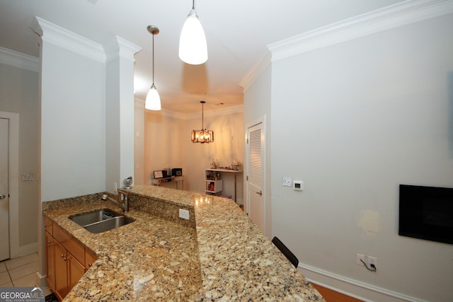 kitchen featuring sink, pendant lighting, and crown molding