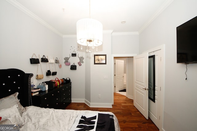 bedroom with dark hardwood / wood-style floors, a chandelier, and crown molding