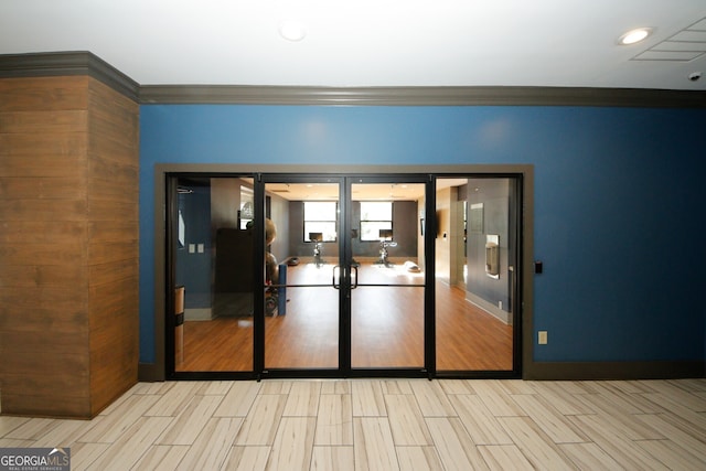 empty room featuring light hardwood / wood-style flooring and crown molding