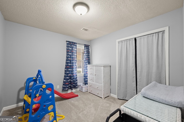 bedroom featuring carpet floors and a textured ceiling