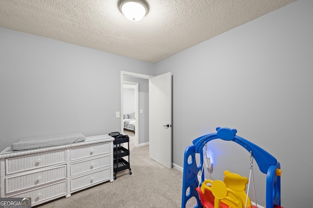 interior space with light colored carpet and a textured ceiling