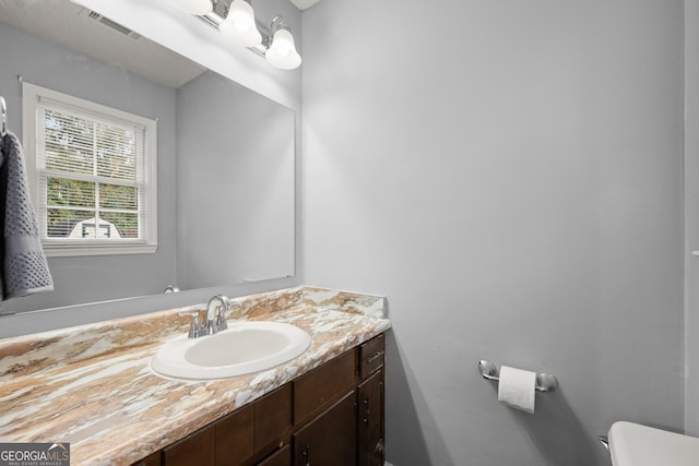 bathroom with vanity and toilet