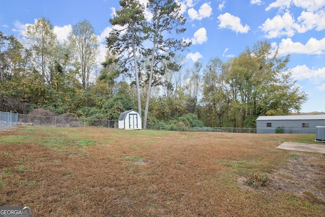 view of yard with central AC unit and a storage unit