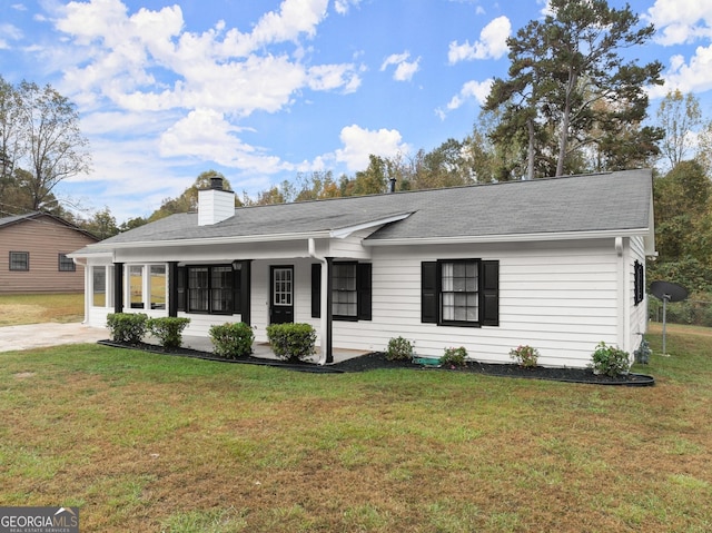 ranch-style home with covered porch and a front lawn