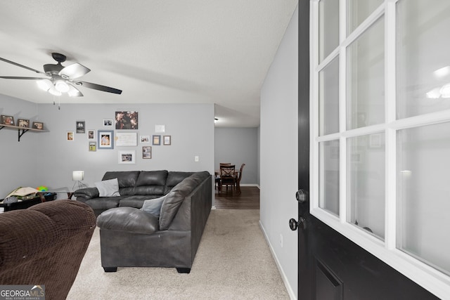 living room featuring ceiling fan and light carpet