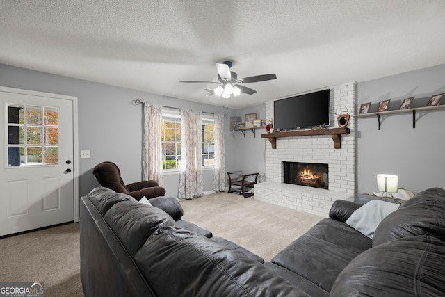 carpeted living room featuring ceiling fan, a fireplace, and a textured ceiling