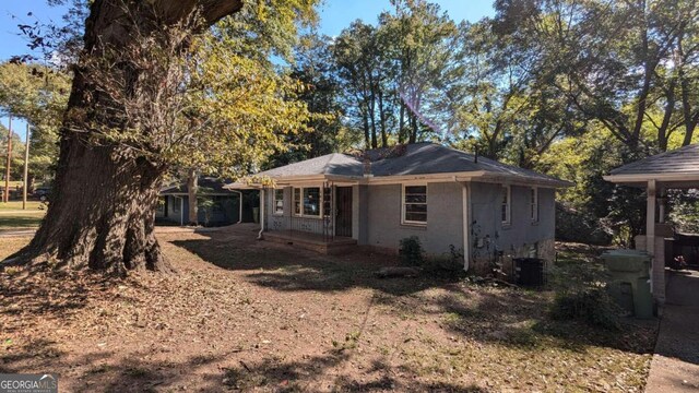 back of house featuring central AC unit and covered porch