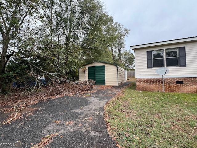 exterior space featuring a storage shed and a lawn