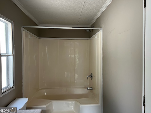 bathroom featuring a textured ceiling, toilet, crown molding, and shower / washtub combination