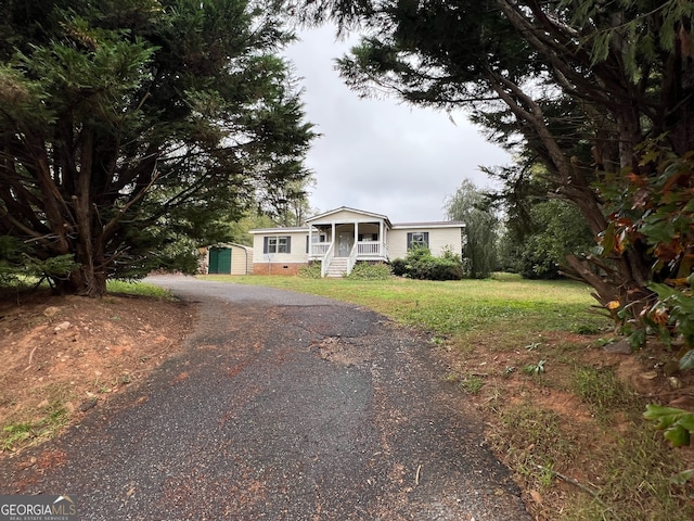 view of front of house with covered porch and a front yard