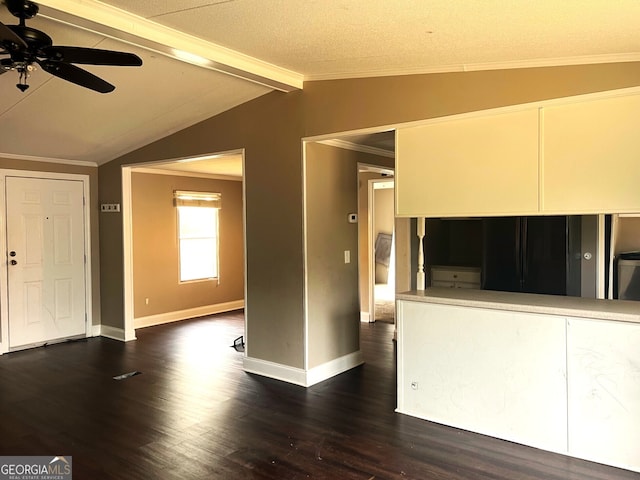 unfurnished living room featuring dark hardwood / wood-style flooring, a textured ceiling, ornamental molding, ceiling fan, and lofted ceiling with beams