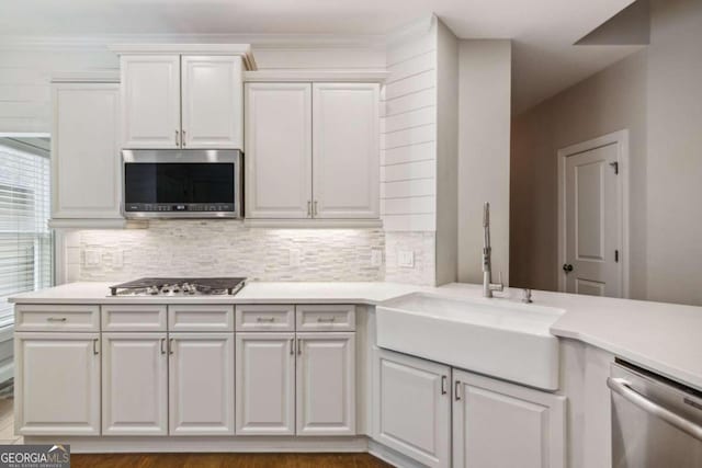 kitchen with white cabinets, sink, and appliances with stainless steel finishes