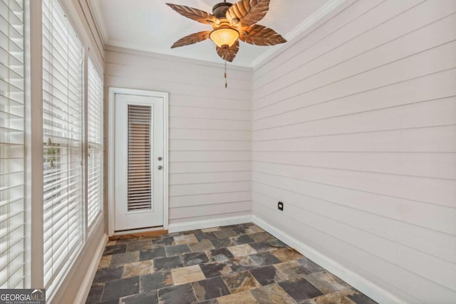 spare room featuring ceiling fan and crown molding