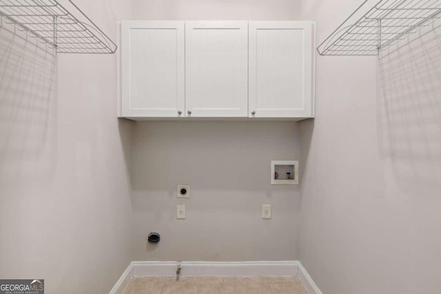 washroom featuring hookup for a washing machine, light tile patterned flooring, cabinets, and electric dryer hookup