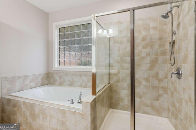 bathroom with shower with separate bathtub