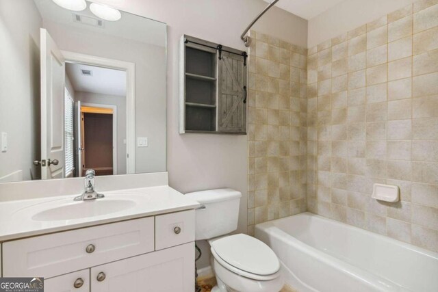 full bathroom with vanity, toilet, and tiled shower / bath combo