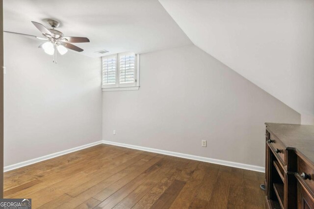 additional living space featuring hardwood / wood-style flooring, ceiling fan, and vaulted ceiling