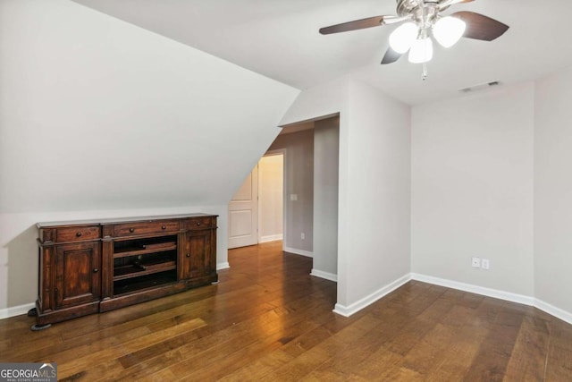 bonus room with ceiling fan, dark hardwood / wood-style flooring, and vaulted ceiling