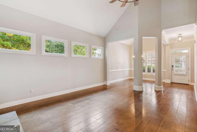 unfurnished room featuring ceiling fan, dark hardwood / wood-style flooring, plenty of natural light, and high vaulted ceiling