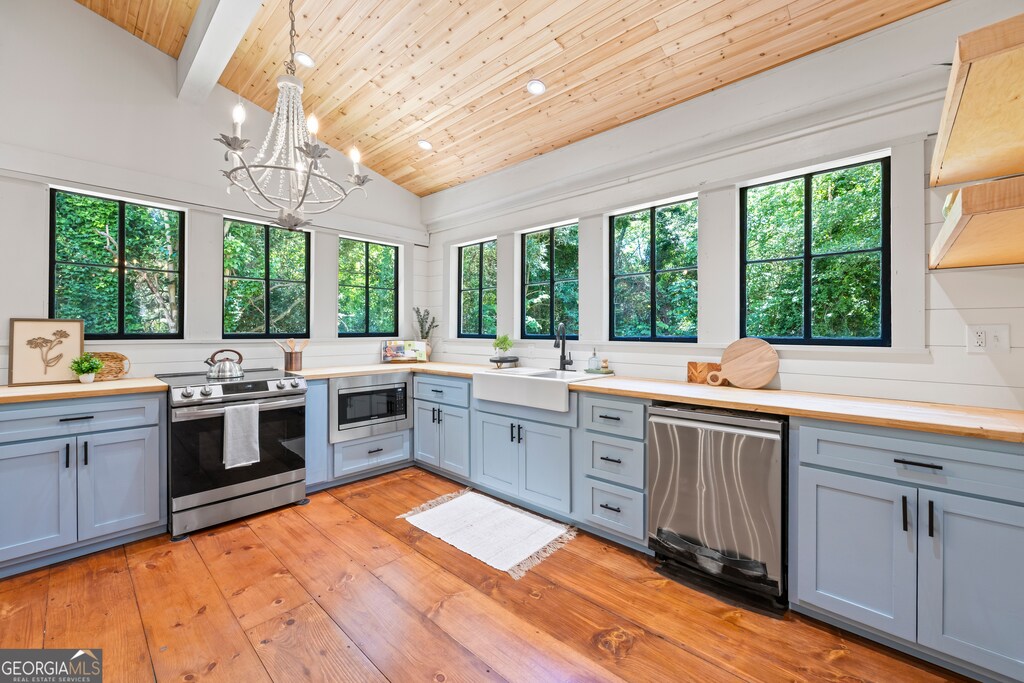 368 Benson St, Hartwell, GA 30643 - kitchen with vaulted ceiling with beams, plenty of natural light, hanging light fixtures, and appliances with stainless steel finishes
