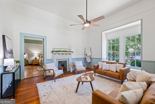 living room with ceiling fan and dark wood-type flooring