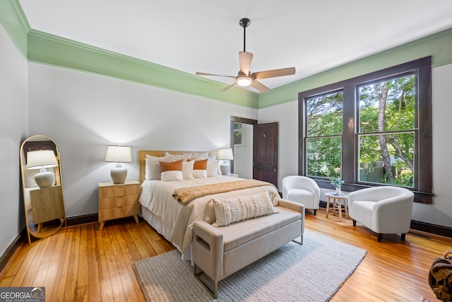 bedroom with light hardwood / wood-style flooring and ceiling fan