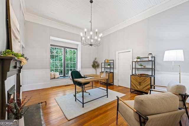 office space with light hardwood / wood-style floors, a notable chandelier, and ornamental molding