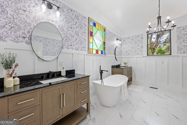 bathroom with crown molding, a bathtub, vanity, and an inviting chandelier