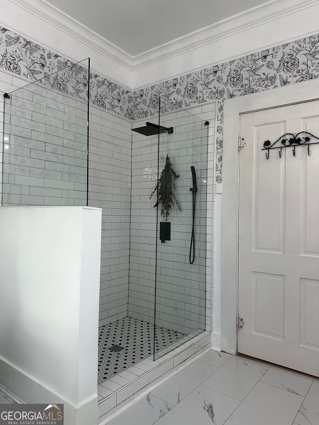 bathroom with a tile shower and crown molding