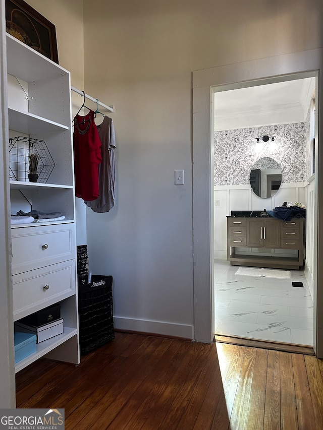 spacious closet featuring dark hardwood / wood-style flooring