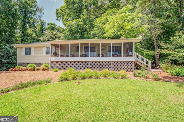 view of front of property with a front lawn and a sunroom