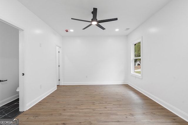 spare room with wood-type flooring and ceiling fan