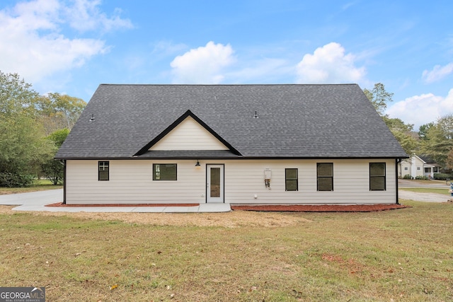 back of house with a yard