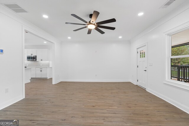 spare room featuring ornamental molding, dark hardwood / wood-style flooring, and ceiling fan