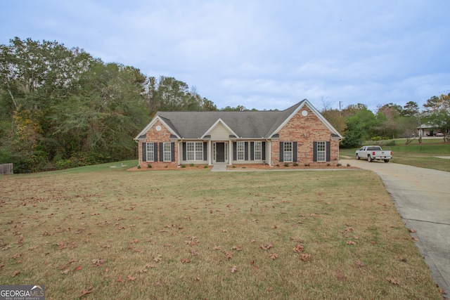 ranch-style house with a porch and a front lawn