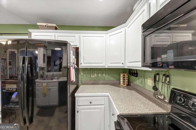 kitchen featuring white cabinetry and black appliances