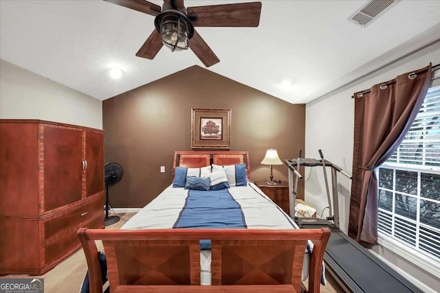 carpeted bedroom featuring vaulted ceiling and ceiling fan